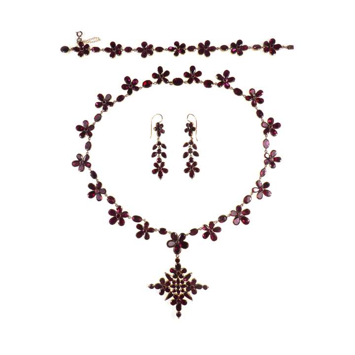 Antique garnet pansy flowerhead cluster suite, comprising a cross pendant necklace, pair of earrings and a bracelet